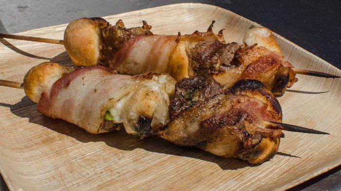 Bacon wrapped venison burger biscuits on a skewer