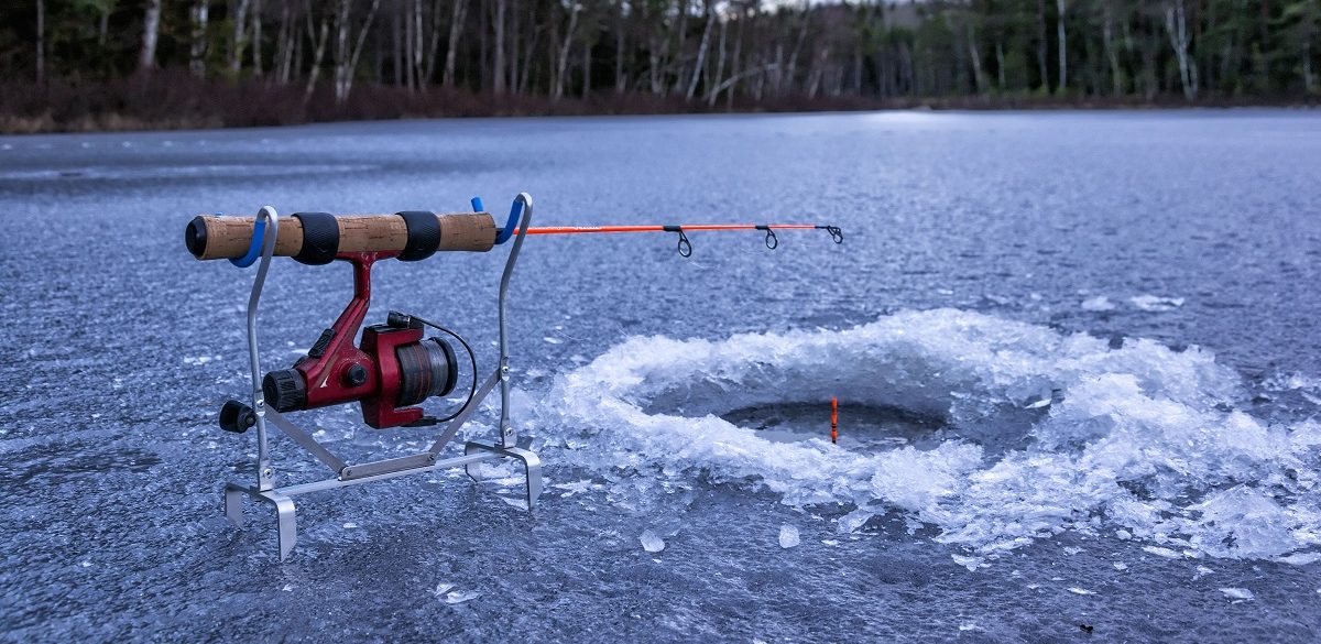 The Angler Drills a Hole in the Ice for Ice Fishing Stock Image