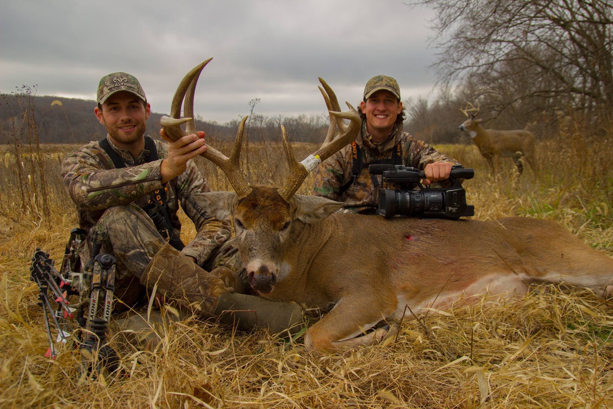 Hunters pose for a picture after taking a big buck on iowa public land
